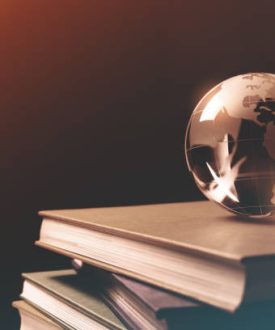 Close-up of Glass Globe on a Stack of Books.